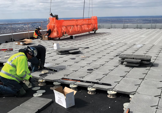 Technicians with Eagle One Roofing Contractors Inc. install the Guardian Paver System at 30 Hudson Yards.